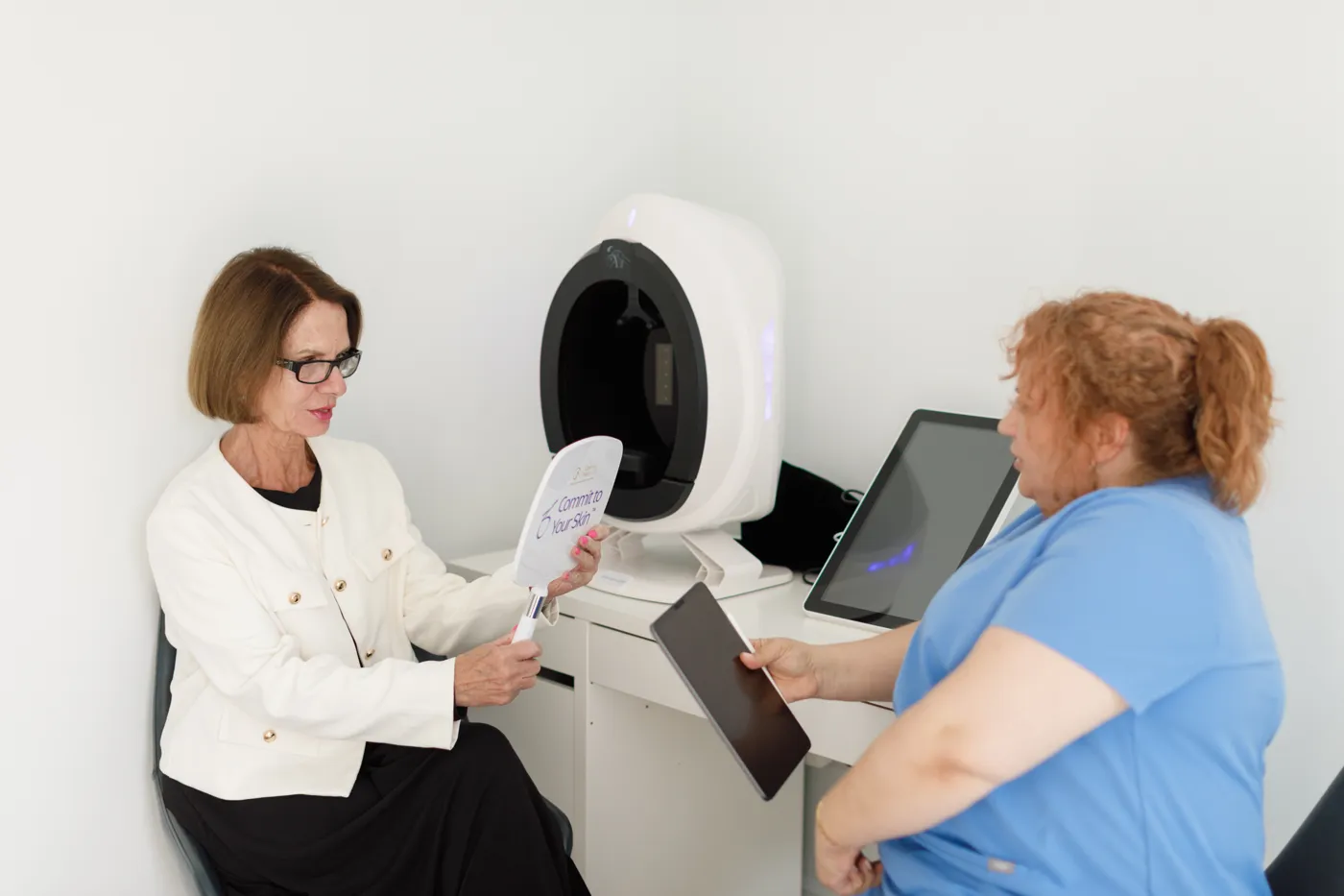 Dr Tania going through a skin analysis with a client at Cosmetic Medicine